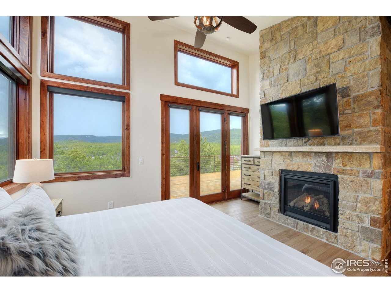 23 Ridge View Road Nederland, CO 80466 - Photo 17 of 38 a bedroom with a bed and a fireplace