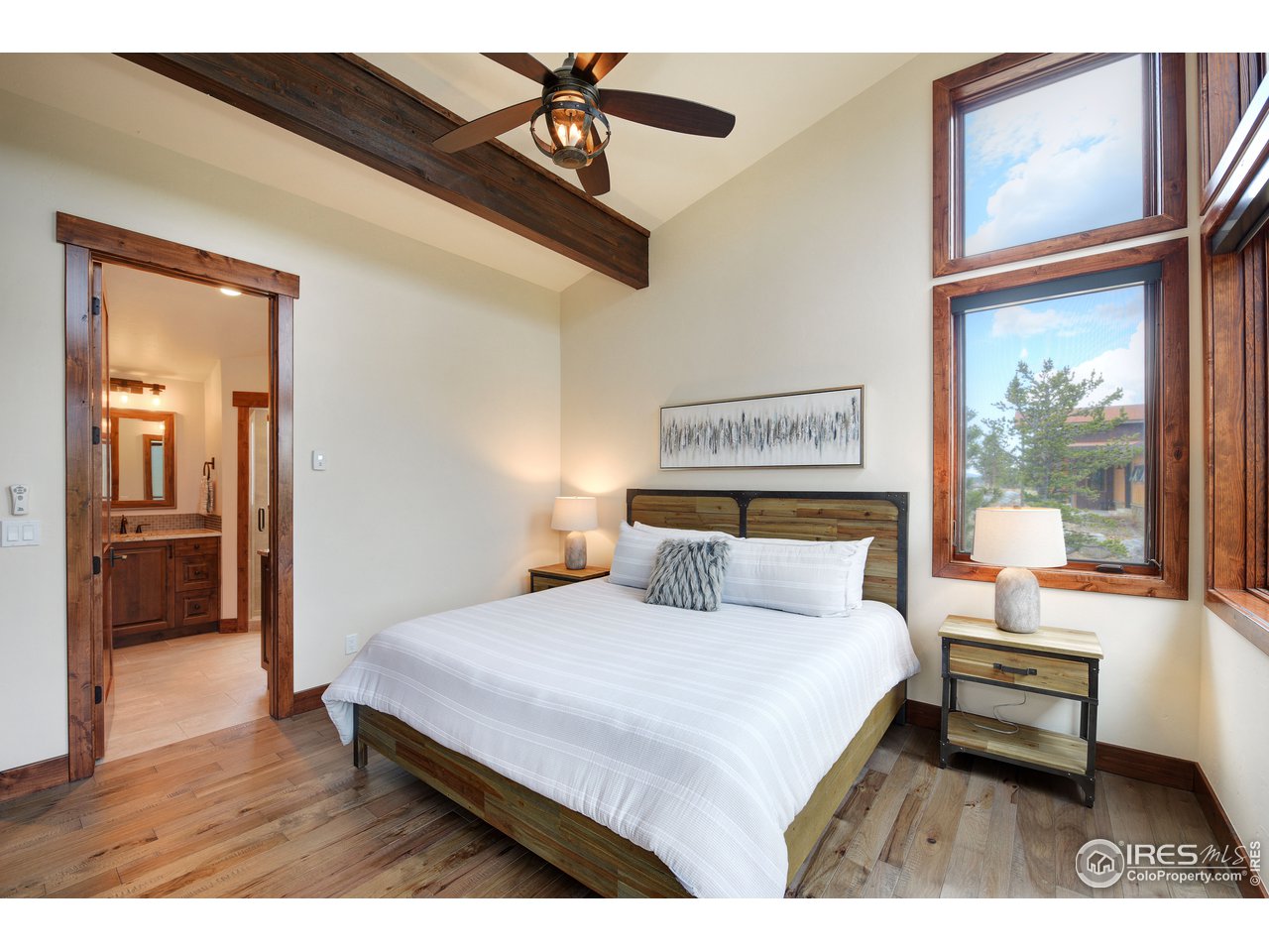 23 Ridge View Road Nederland, CO 80466 - Photo 18 of 38 a bedroom with a bed and a large mirror