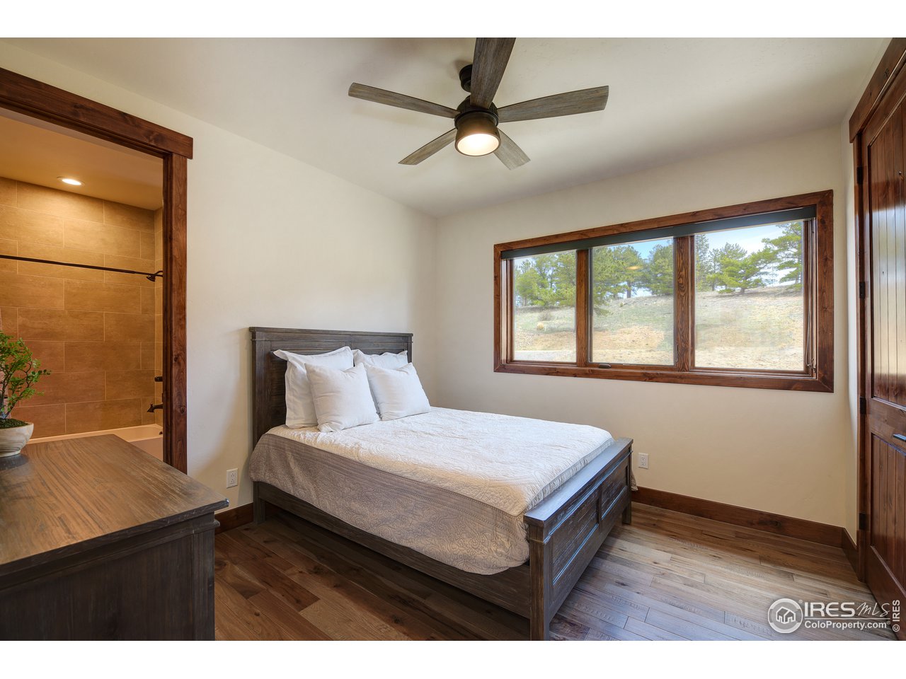 23 Ridge View Road Nederland, CO 80466 - Photo 19 of 38 a bedroom with a bed and a window