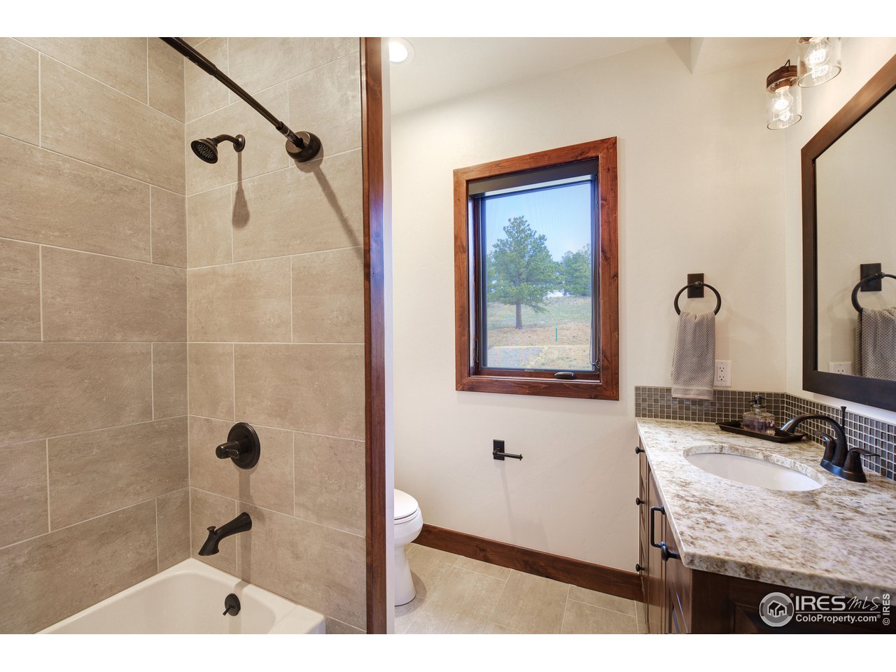 23 Ridge View Road Nederland, CO 80466 - Photo 20 of 38 a bathroom with a granite countertop sink a mirror and shower