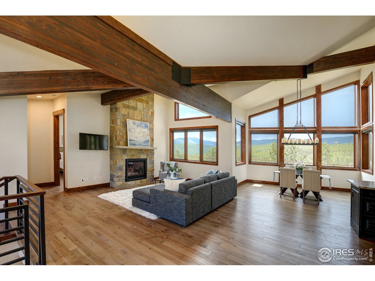23 Ridge View Road Nederland, CO 80466 - Photo 2 of 38 a living room with furniture large window and fireplace