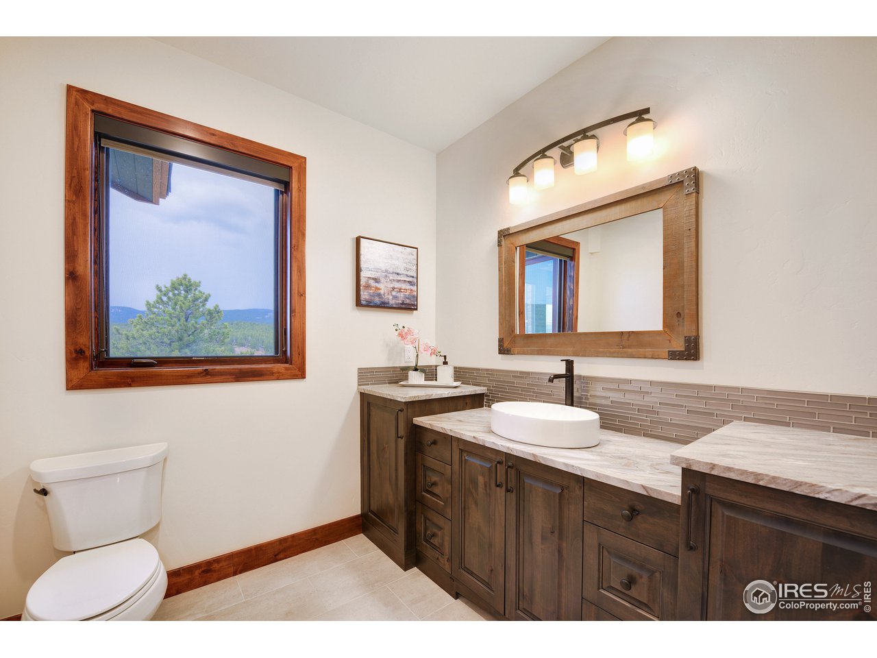 23 Ridge View Road Nederland, CO 80466 - Photo 22 of 38 a bathroom with a toilet sink and mirror
