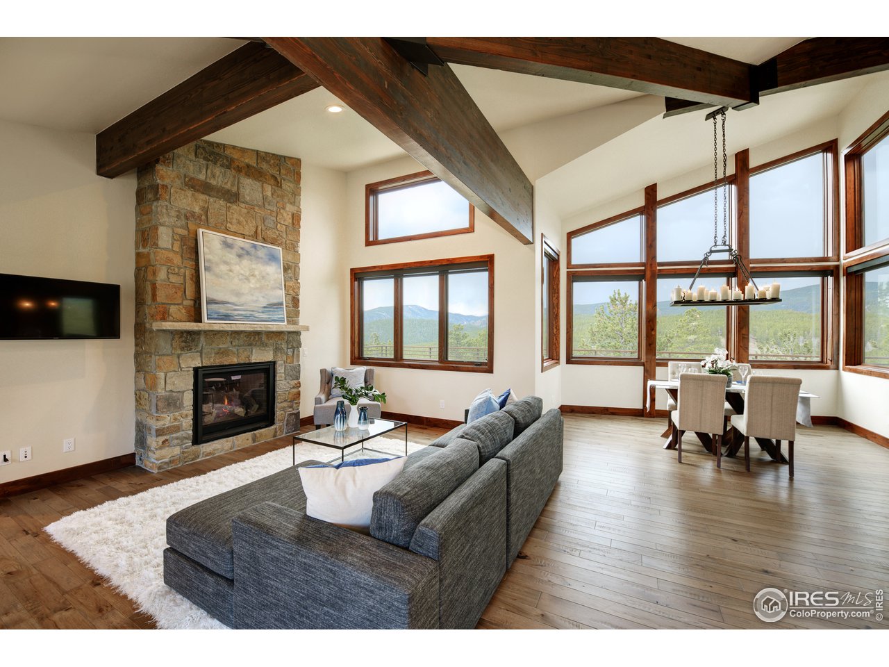 23 Ridge View Road Nederland, CO 80466 - Photo 3 of 38 a living room with furniture large window and a fireplace