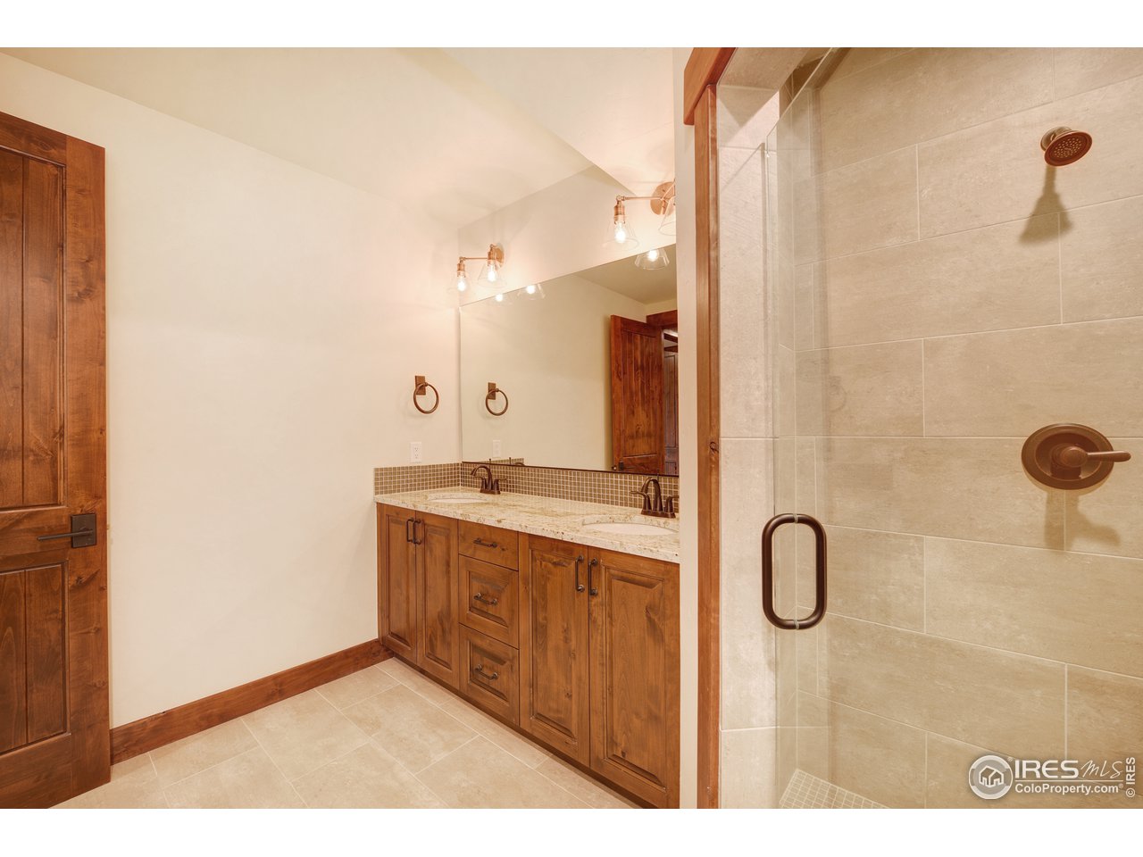 23 Ridge View Road Nederland, CO 80466 - Photo 34 of 38 a bathroom with a double vanity sink and a mirror