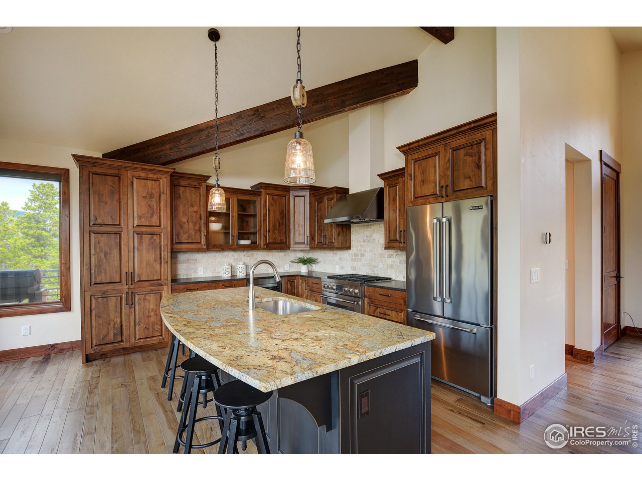 23 Ridge View Road Nederland, CO 80466 - Photo 9 of 38 a kitchen with stainless steel appliances granite countertop a kitchen island a refrigerator a table and chairs