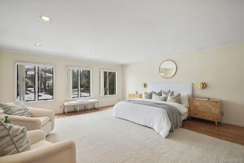 a bedroom with bed and a large window