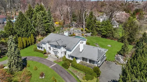 an aerial view of a house with yard swimming pool and outdoor seating