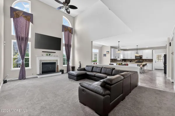 a kitchen with stainless steel appliances kitchen island granite countertop a table and chairs in it