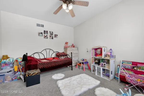 a bedroom with furniture and a baby crib