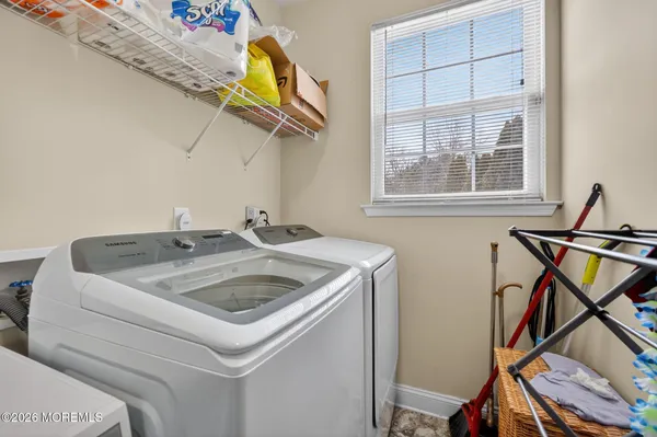 a utility room with a sink dryer and washer