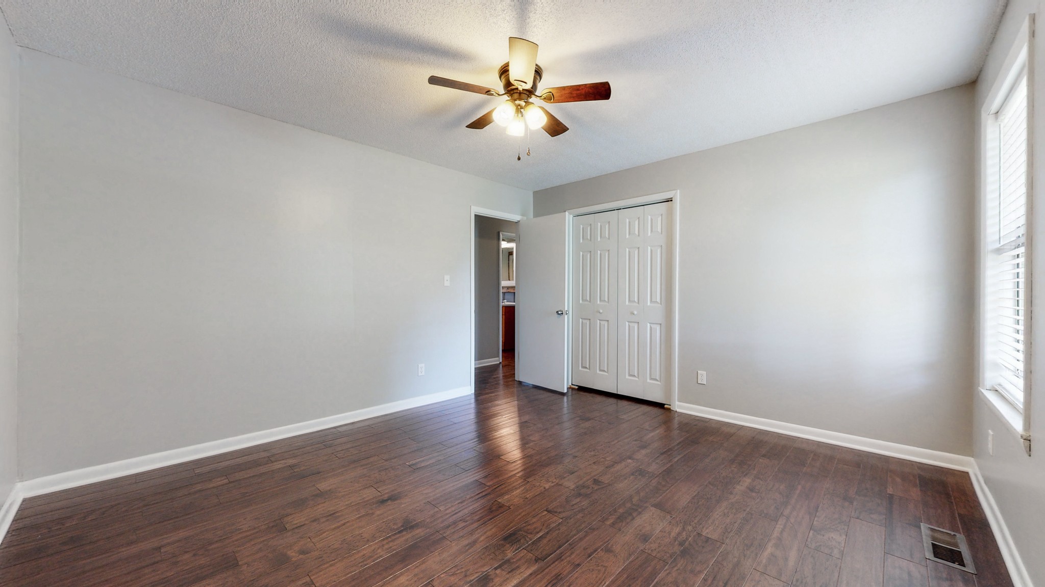 83 Hotel Road Flintville, TN 37335 - Photo 14 of 39 an empty room with wooden floor and ceiling fan