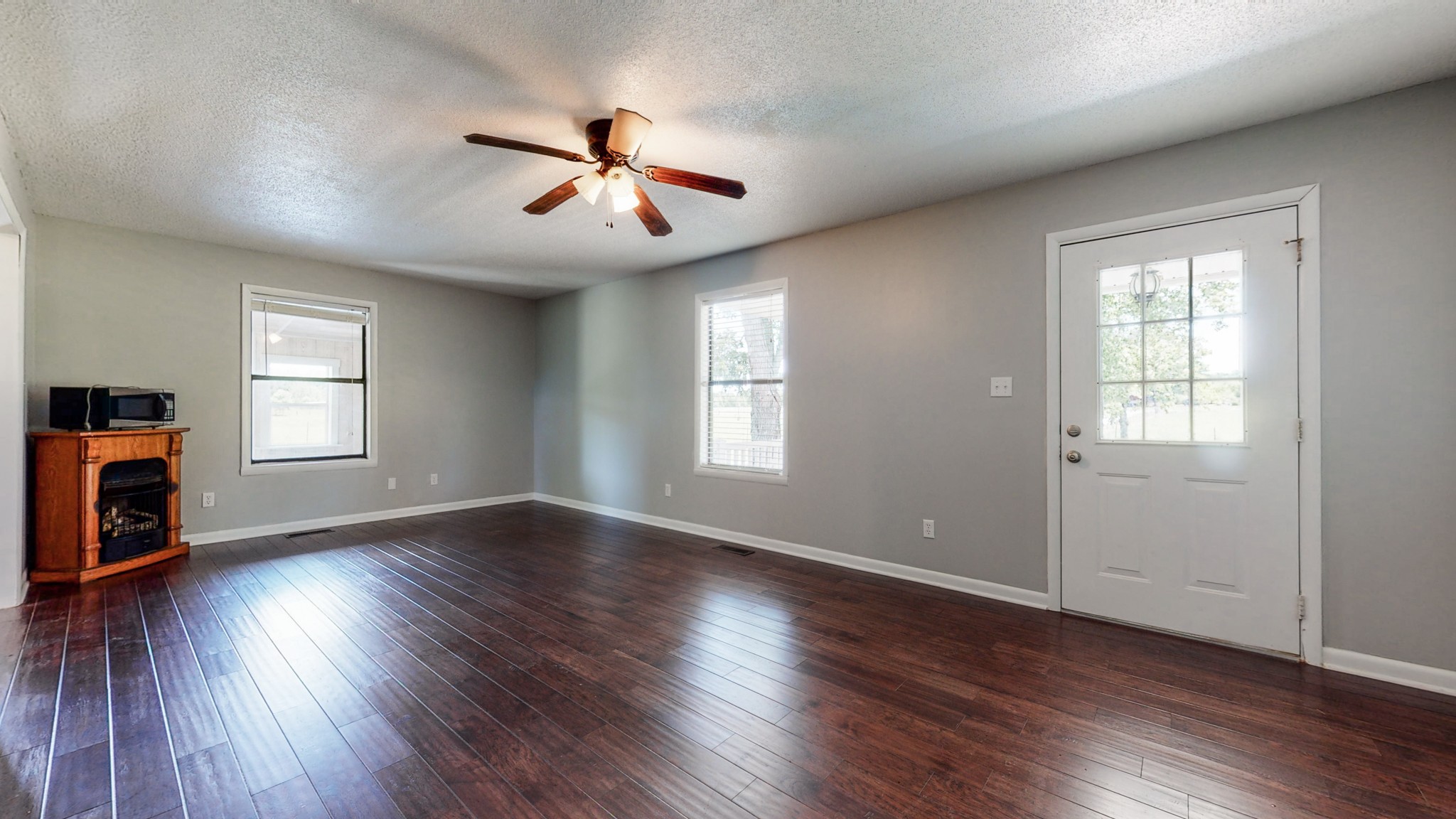83 Hotel Road Flintville, TN 37335 - Photo 5 of 39 a view of an empty room with wooden floor and a window