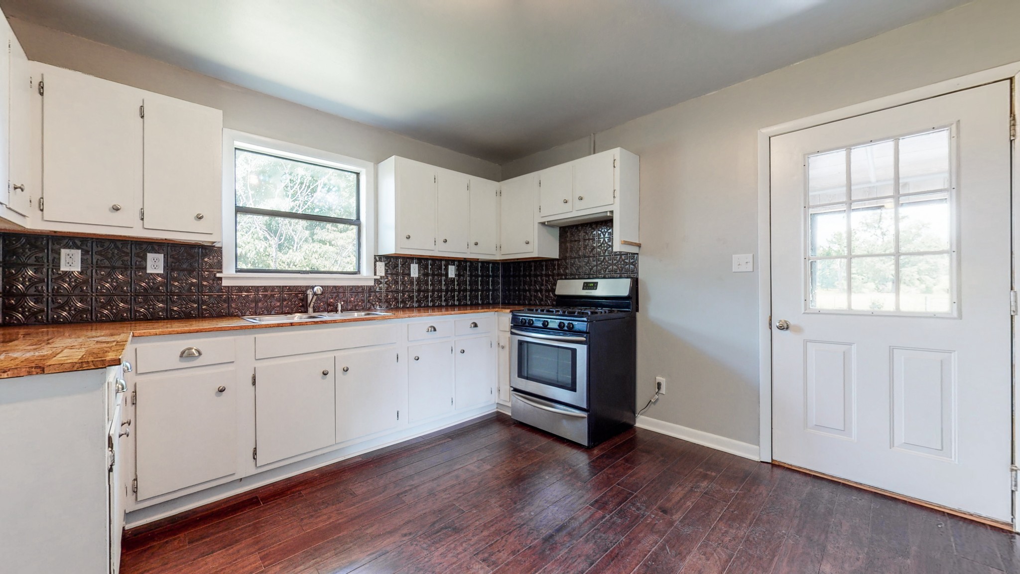 83 Hotel Road Flintville, TN 37335 - Photo 8 of 39 a kitchen with granite countertop white cabinets and wooden floor