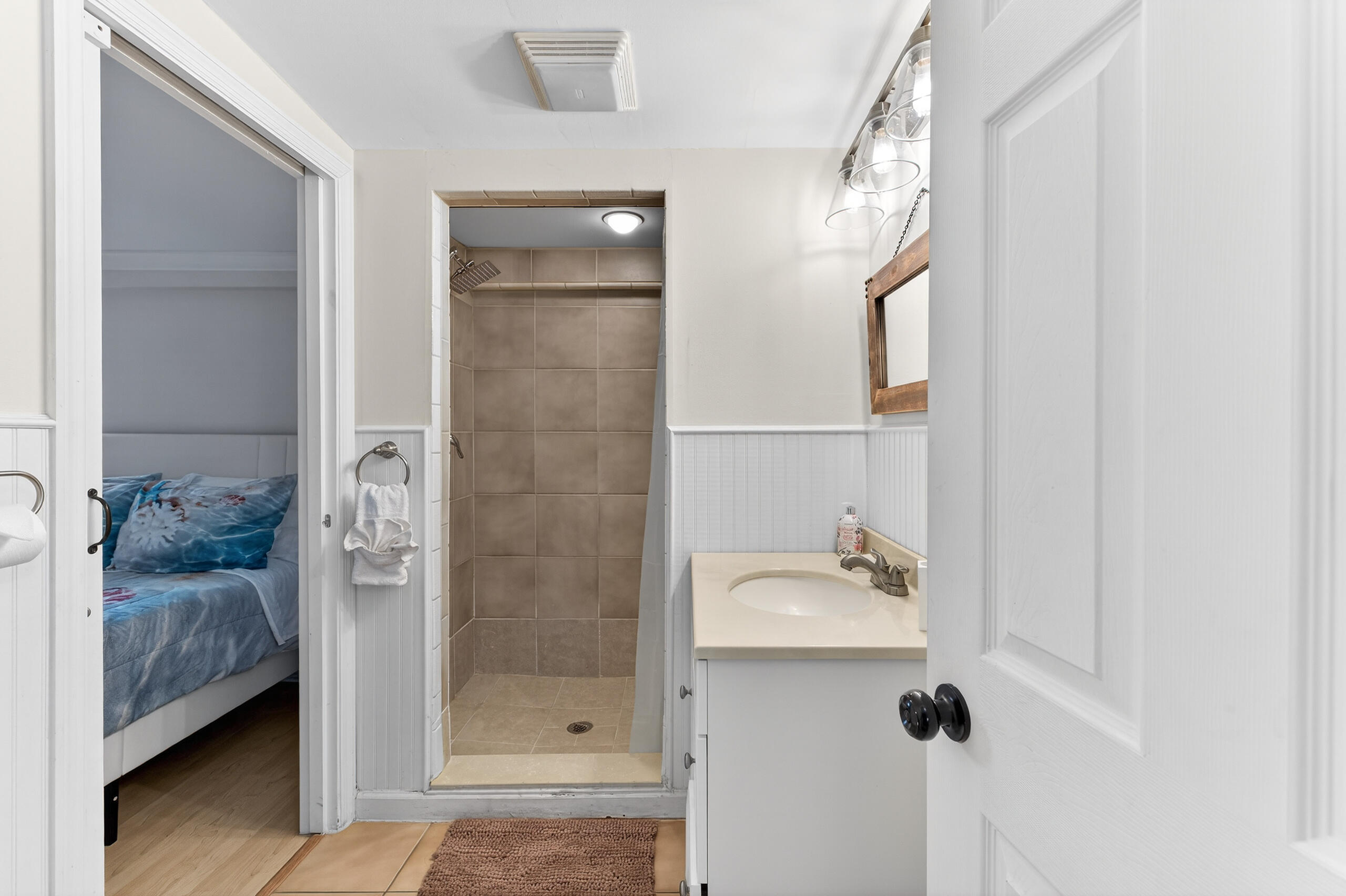 27 Riviera Drive Key West, FL 33040 - Photo 13 of 23 a bathroom with a sink a mirror and shower