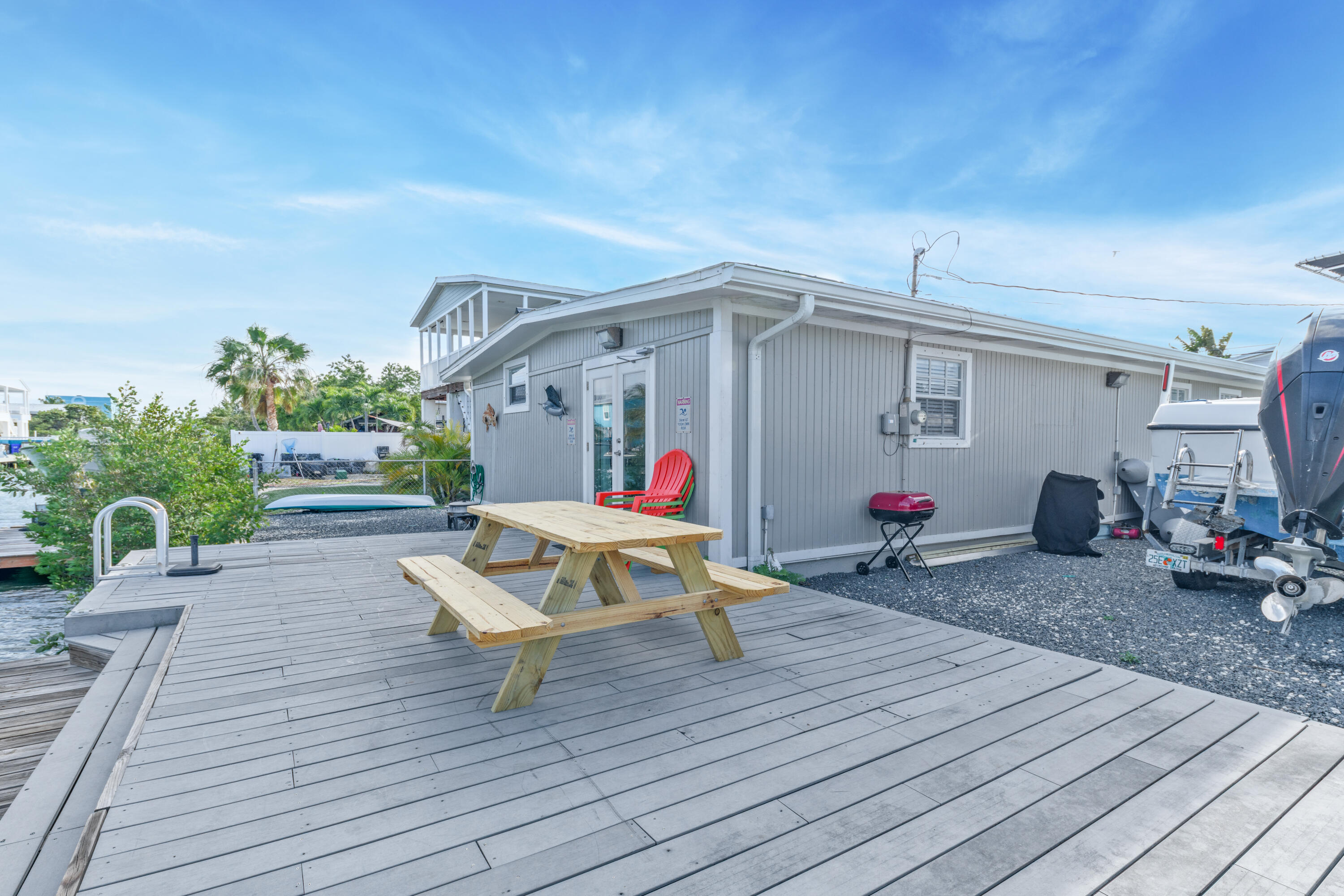 27 Riviera Drive Key West, FL 33040 - Photo 21 of 23 a view of a deck with wooden floor and outdoor seating