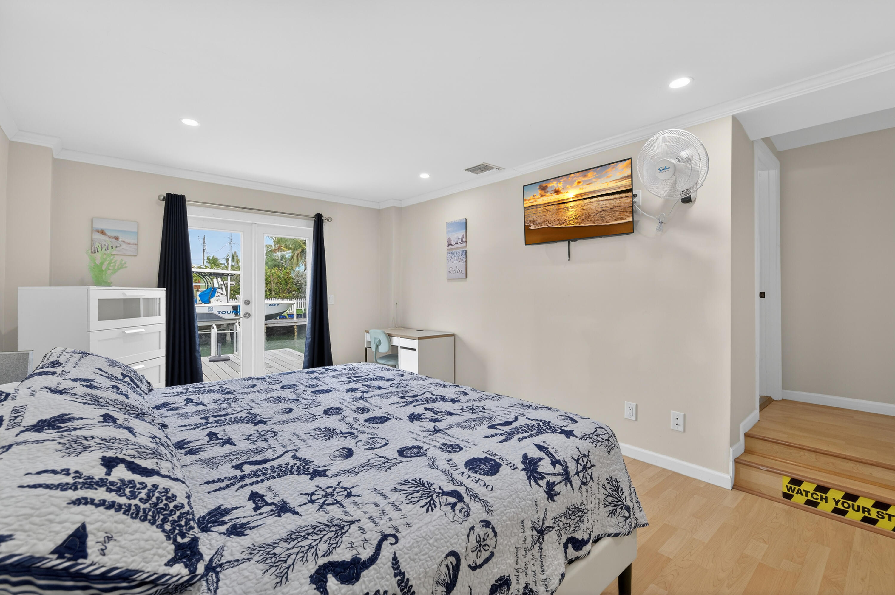 27 Riviera Drive Key West, FL 33040 - Photo 3 of 23 a bedroom with a bed and a dresser in it