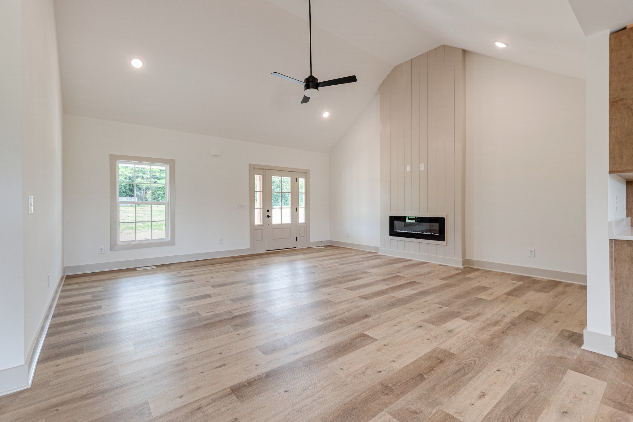 922 Butler Bridge Road Portland, TN 37148 - Photo 8 of 30 an empty room with wooden floor and windows