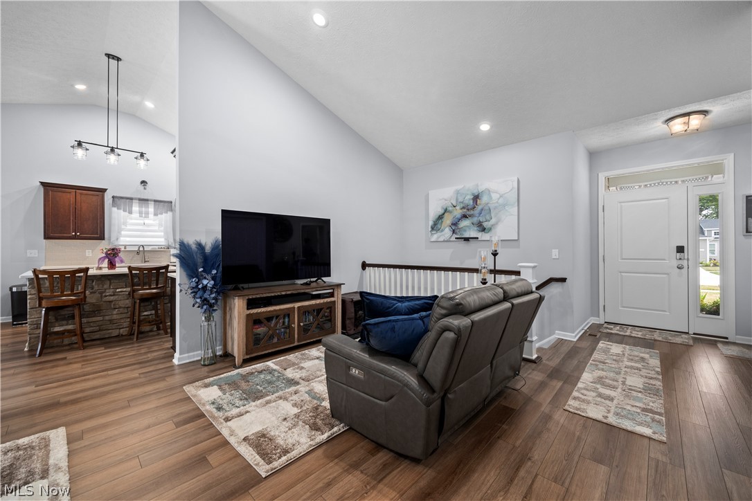 109 West Spring Drive Elyria, OH 44035 - Photo 6 of 46 Vaulted ceilings enhance this living area featuring wood-finish flooring