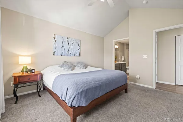a bedroom with a bed and a painting on the wall