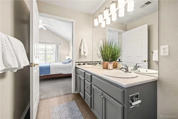 a bathroom with a double vanity sink and a mirror