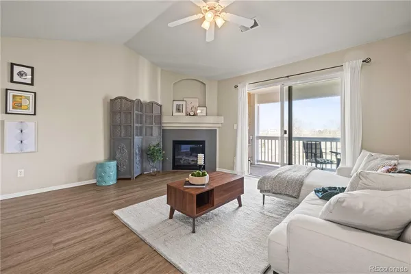 a living room with furniture fireplace and window