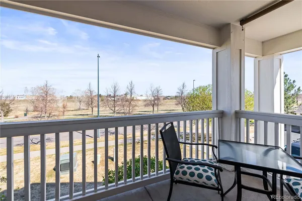 a view of a balcony with furniture