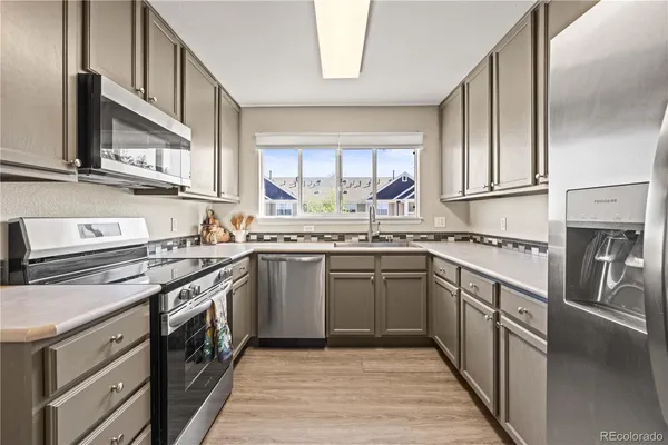 a kitchen with stainless steel appliances granite countertop a stove and a sink