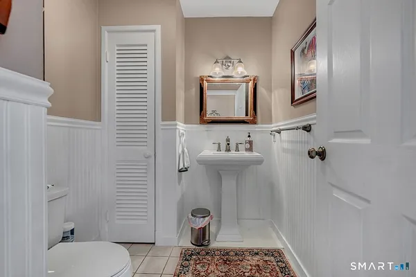 a bathroom with a sink toilet and mirror