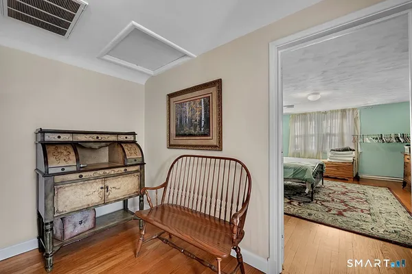 a bedroom with furniture and a window