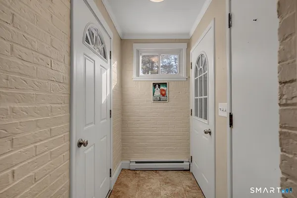a view of front door with wooden floor