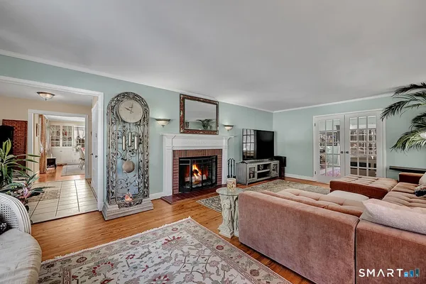 a living room with furniture a flat screen tv and a fireplace