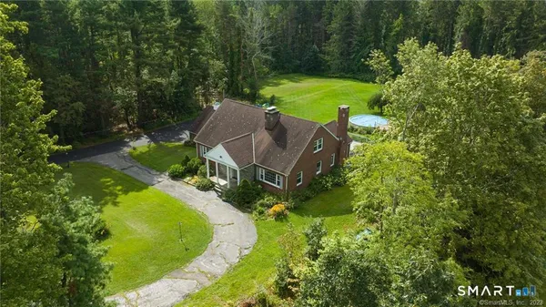 an aerial view of a house with a yard basket ball court and outdoor seating