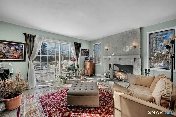 a living room with furniture and a fireplace