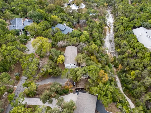 a aerial view of a house with a yard and outdoor seating