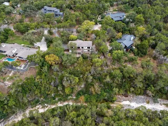 an aerial view of a house with a yard and outdoor seating