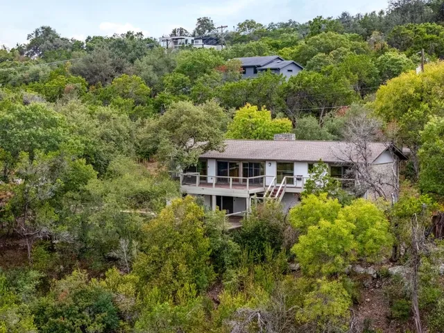 an aerial view of a house with yard and outdoor seating