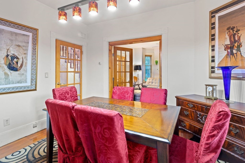 1 Copeland Place Boston, MA 02119 - Photo 12 of 31 a view of a dining room with furniture a chandelier and wooden floor