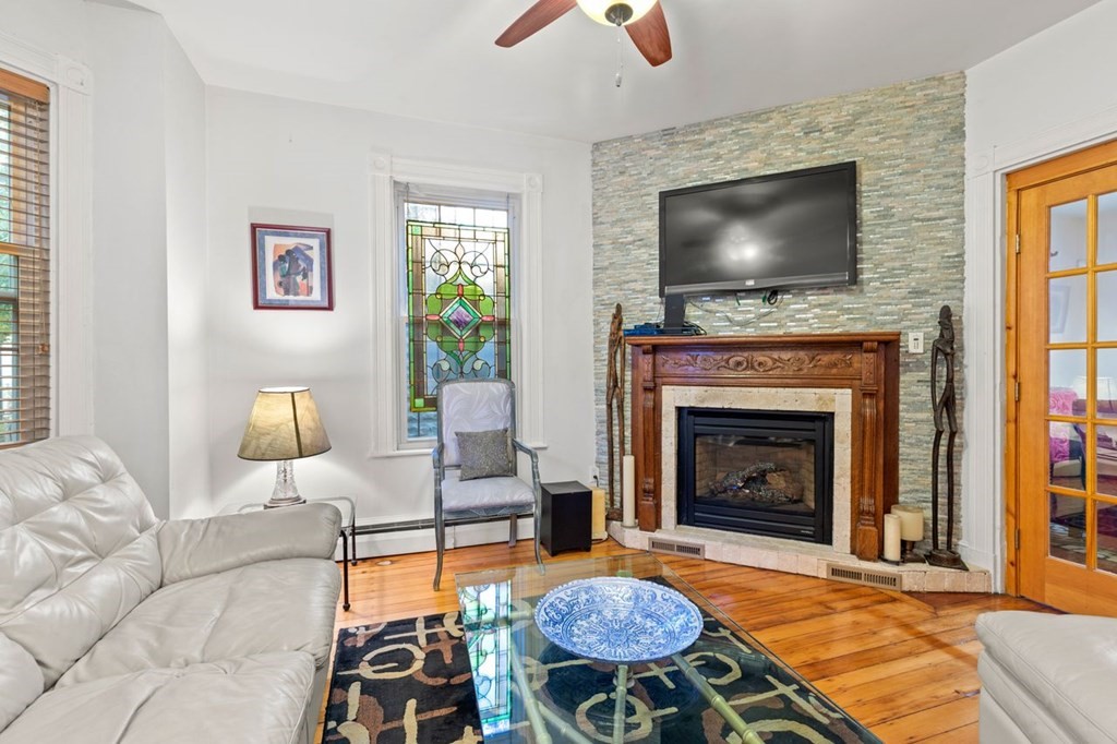 1 Copeland Place Boston, MA 02119 - Photo 8 of 31 a living room with furniture and a flat screen tv