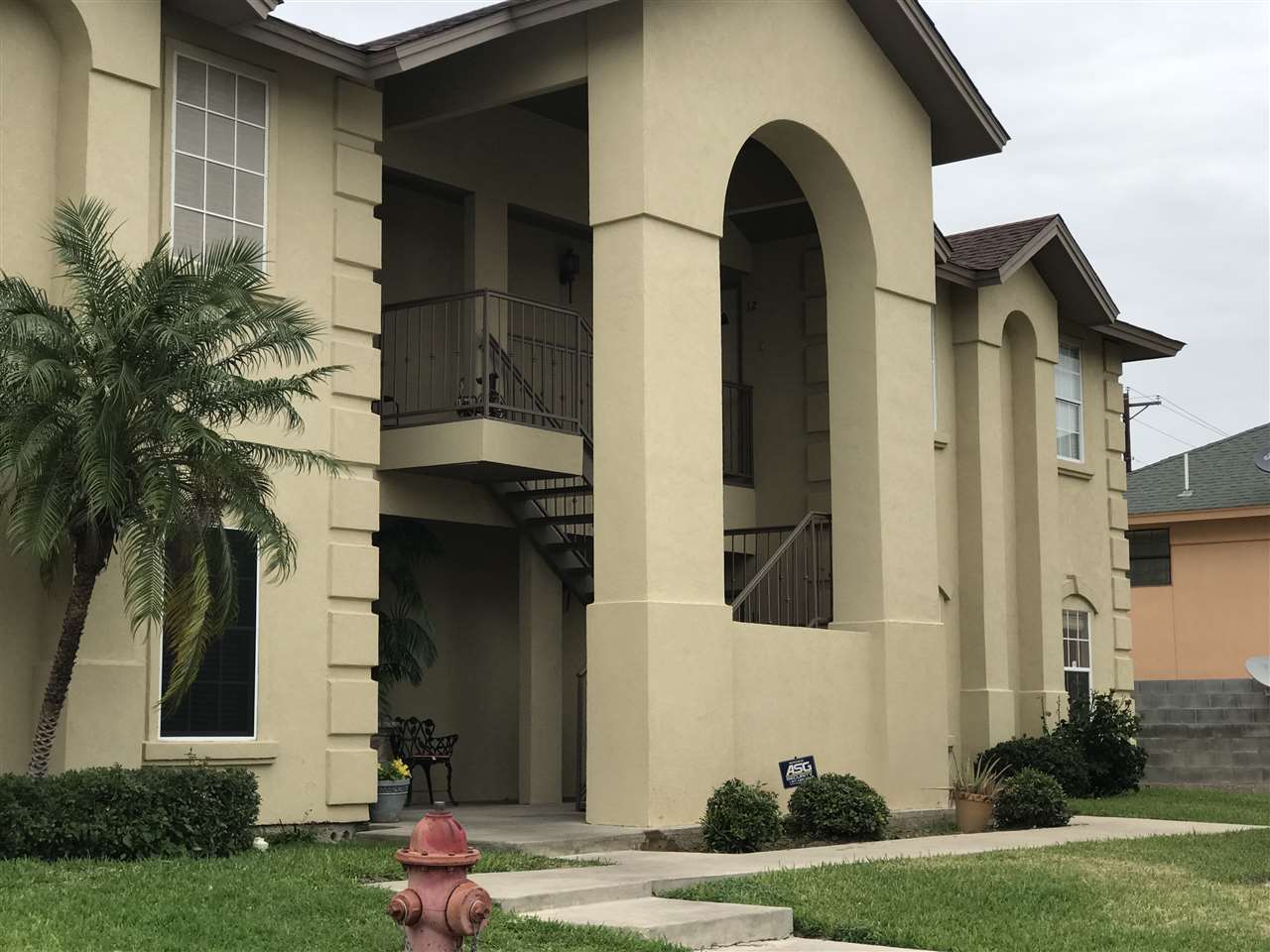 9804 Cantera Court, Unit 11 Laredo, TX 78045 - Photo 1 of 1 a view of a brick house with a yard