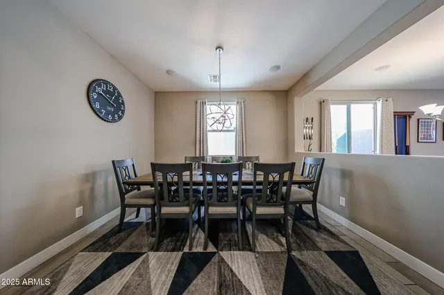 a view of a dining room with furniture and a chandelier