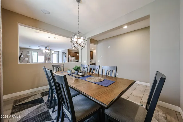 a view of a dining room with a table and chairs