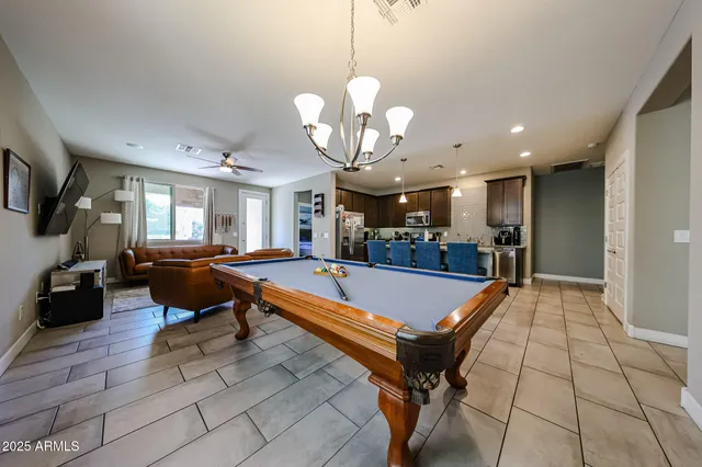 a room with table tennis air hockey table and arcade game machine