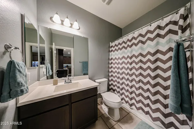 a bathroom with a sink mirror and toilet
