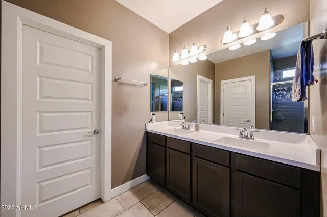a bathroom with a sink double vanity and a mirror