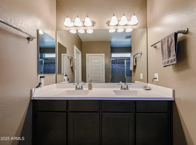a spacious bathroom with a double vanity sink and a mirror