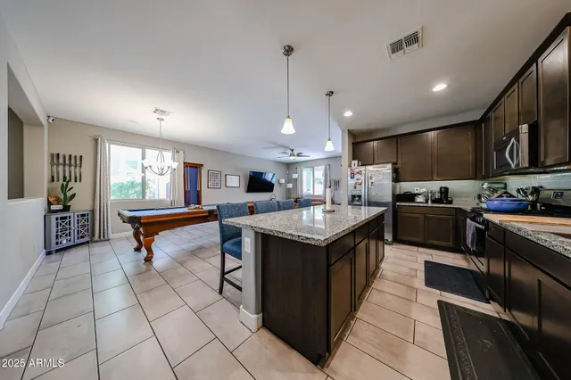 a bedroom with a bed and large windows