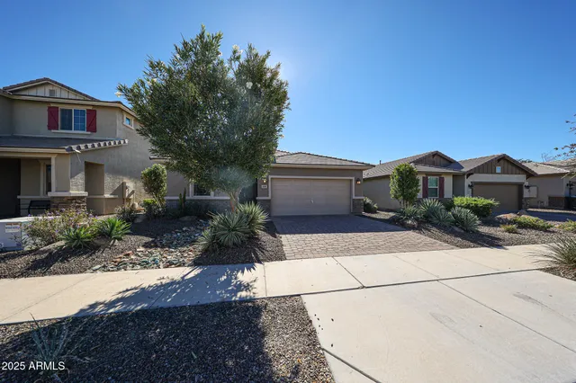 a front view of a house with a yard and a garage