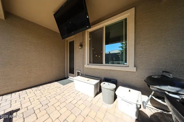 a view of a patio with table and chairs potted plants and a large tree