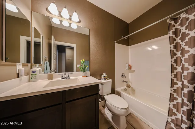 a bathroom with a double vanity sink mirror and toilet