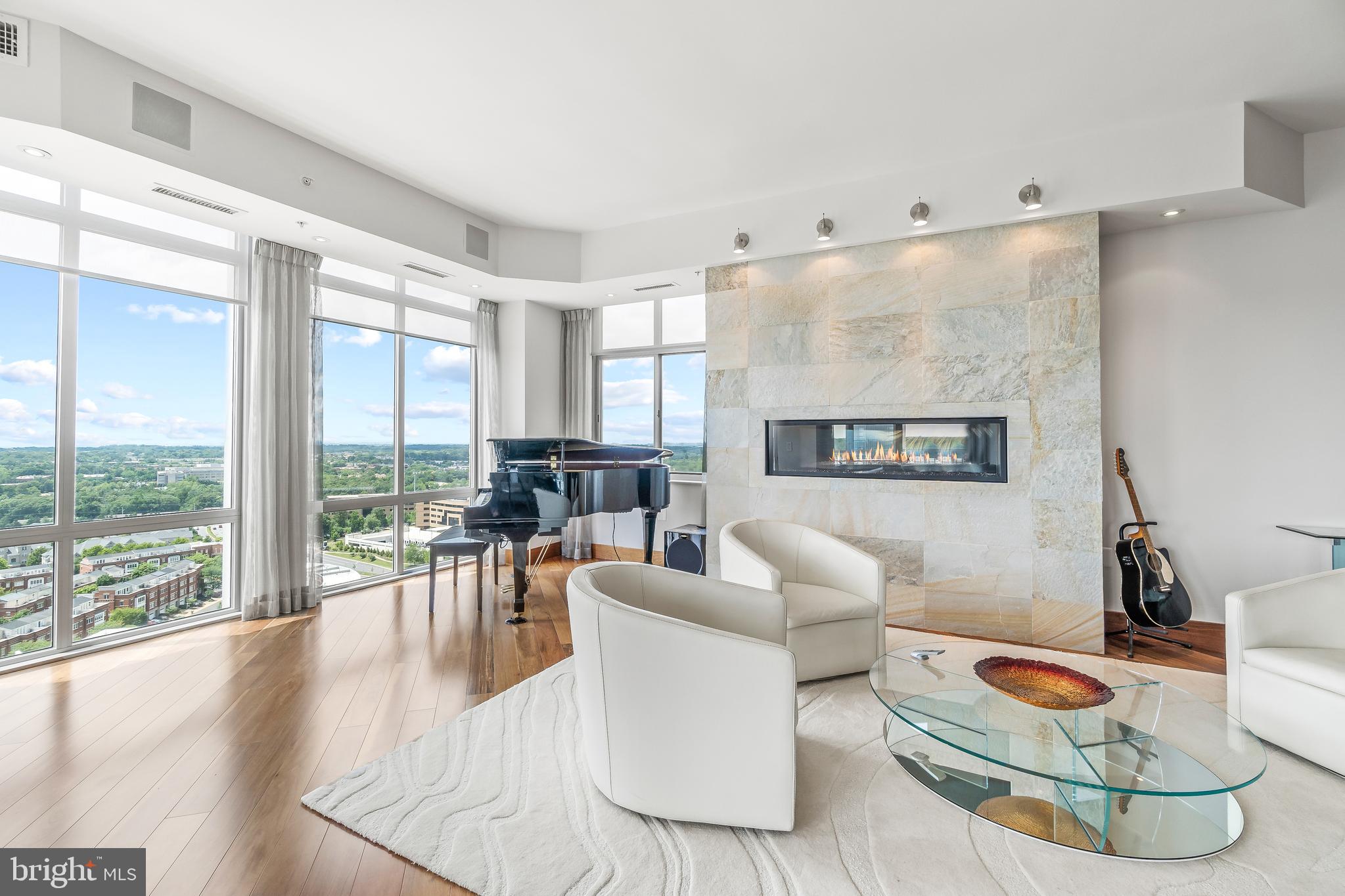 a living room with furniture and a floor to ceiling window